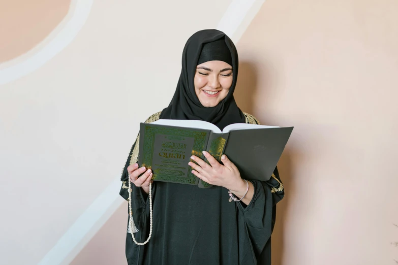 a woman in a head covering is reading a book