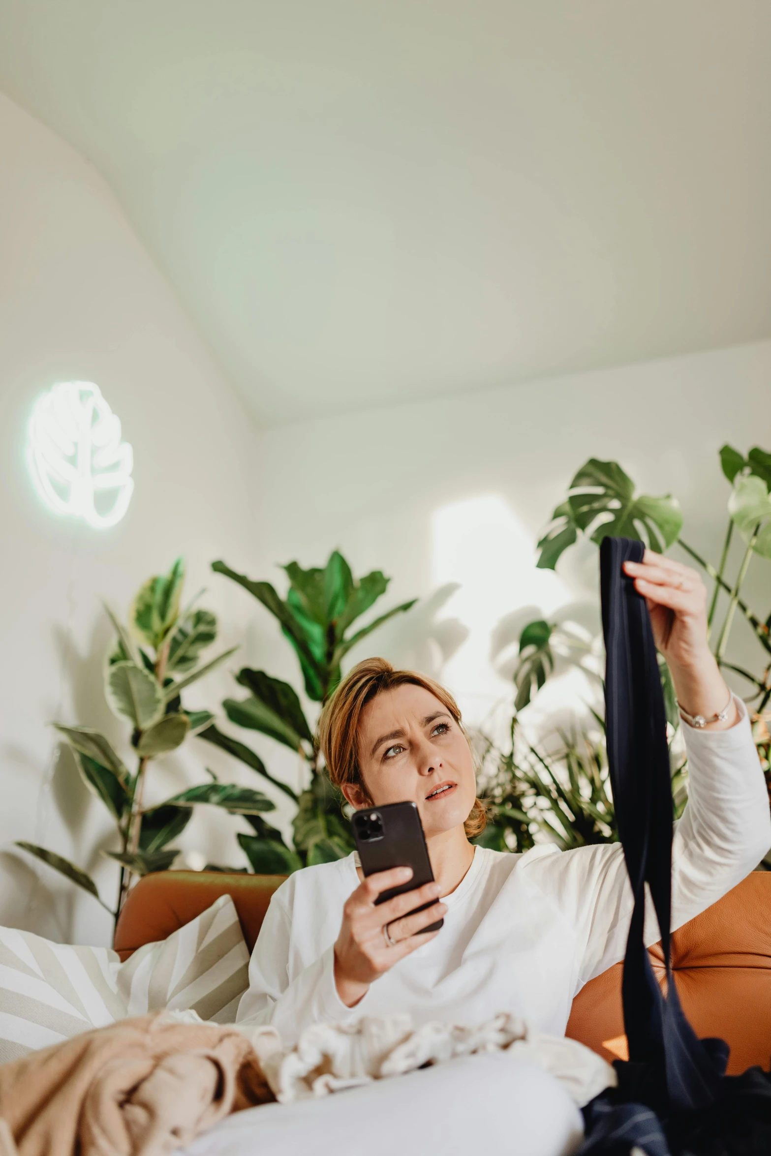 a woman lying on the bed with her phone