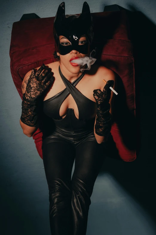 a female in a cat costume smoking on a cigarette