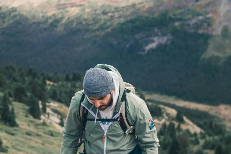 a hiker is standing on top of a hill