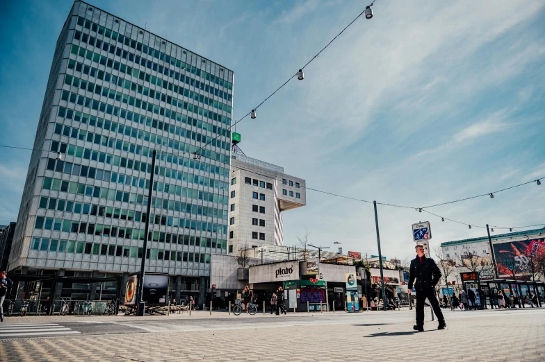 a man is standing near some buildings on the ground