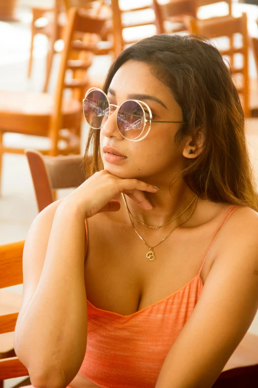 a woman wearing sunglasses sitting in a restaurant