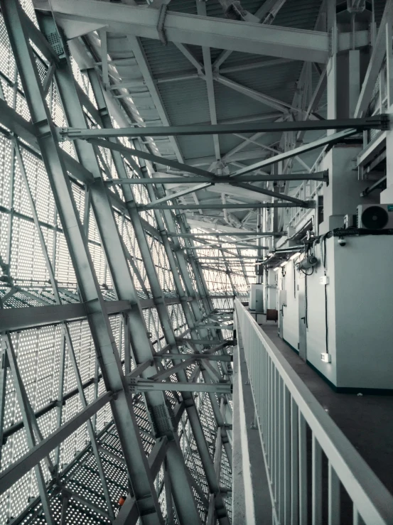 inside view of a building with large, long metal beams