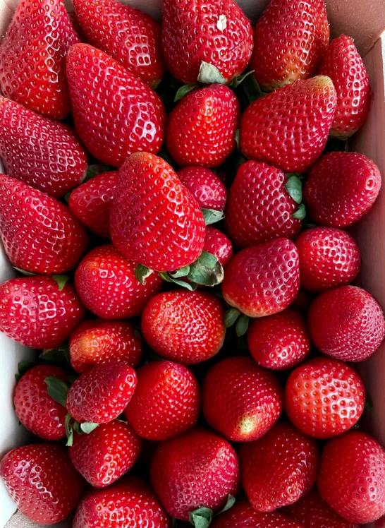 a group of strawberries that are in a box