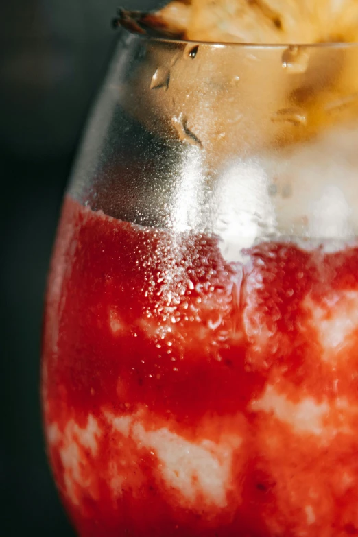 an apple dessert being held in a wine glass