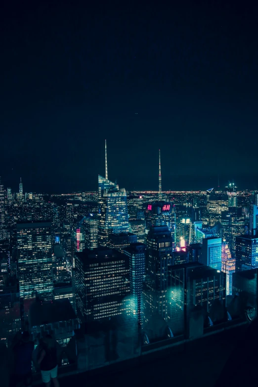 the skyline and lights of an urban city are illuminated in the night