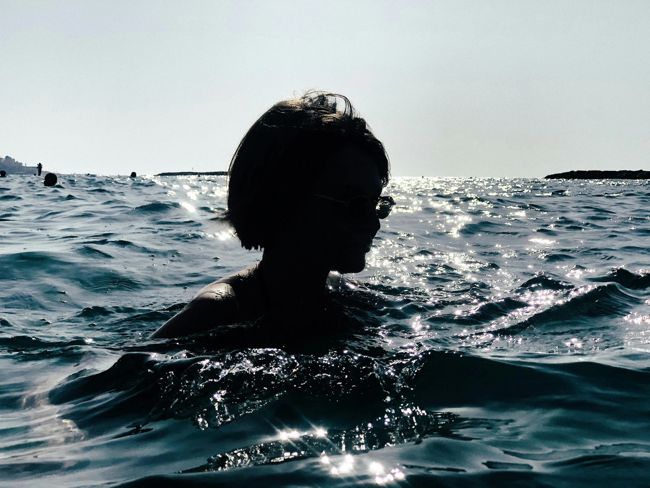 a person in the water with a sky background