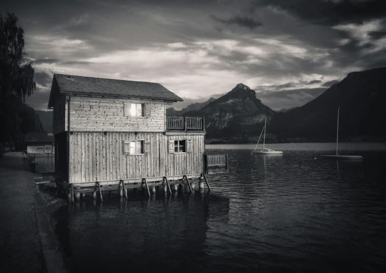 an old wooden shack in the middle of water