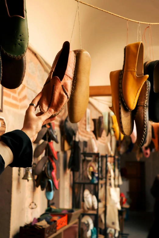 a person holding their shoes on a line in a shop