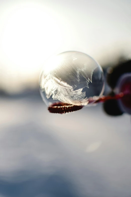 a person's hand is holding a bubble