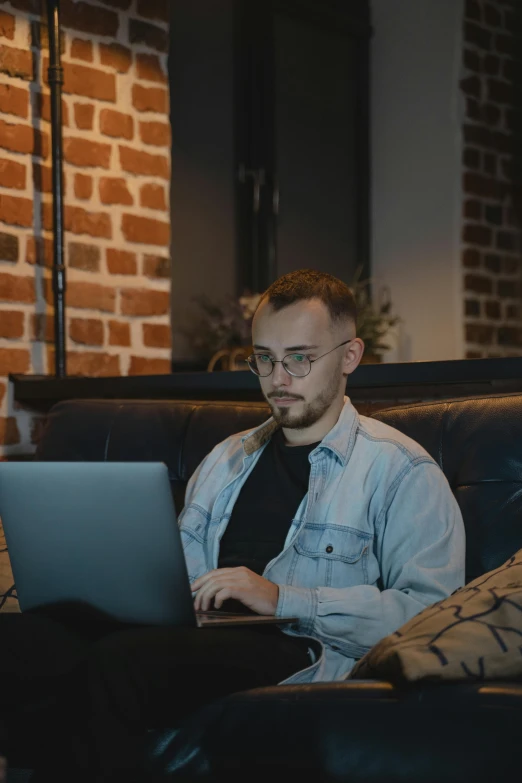 a man using a laptop computer in a cafe