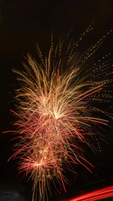 fireworks and a car passing by at night