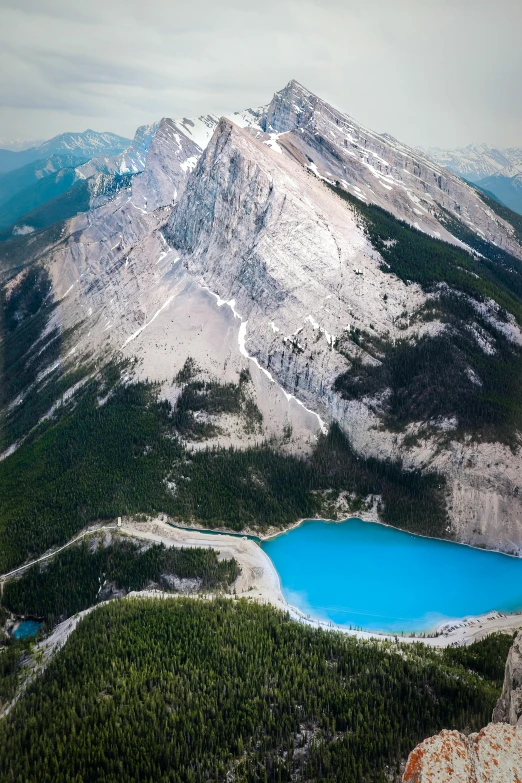 a view of the mountains with a small lake