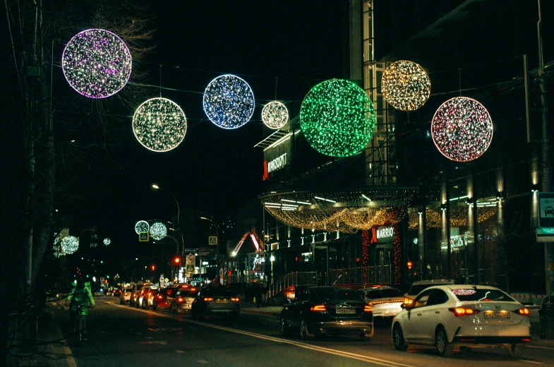 lights hang above a busy street on christmas eve