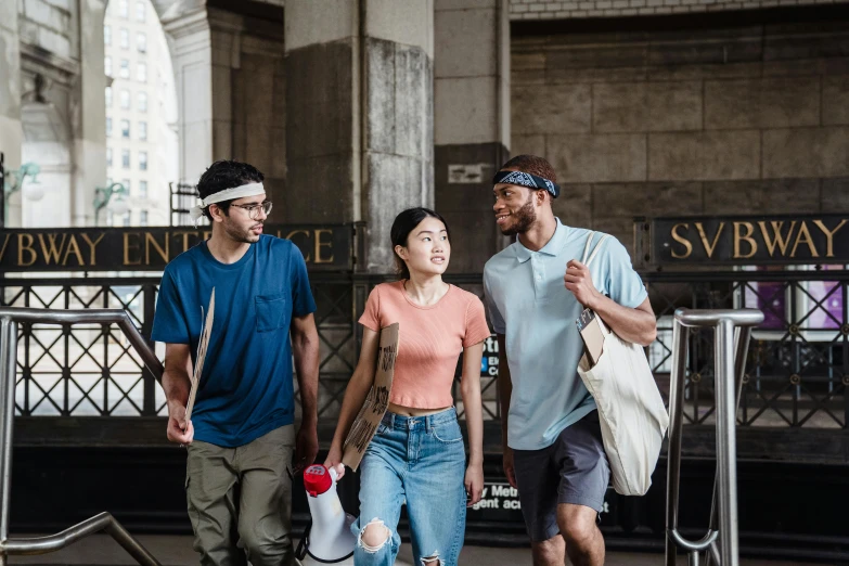 two people are walking with one carrying a bag