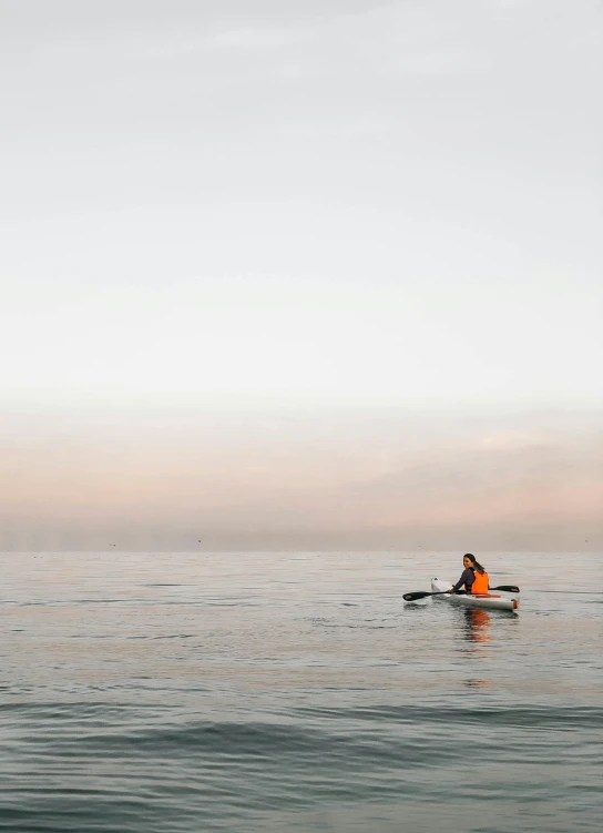 a person riding on top of a boat in the ocean