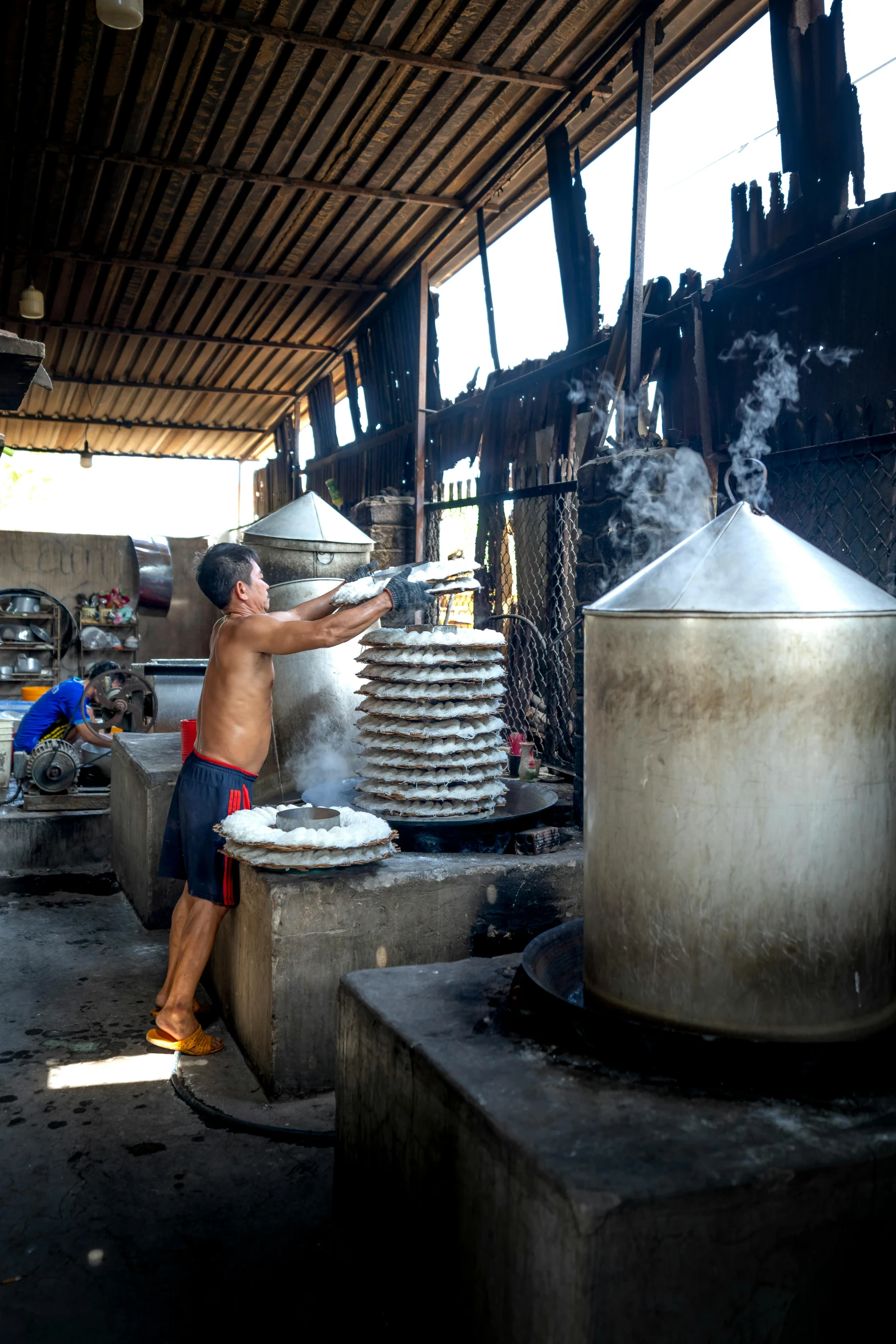 a man preparing food in a large pot