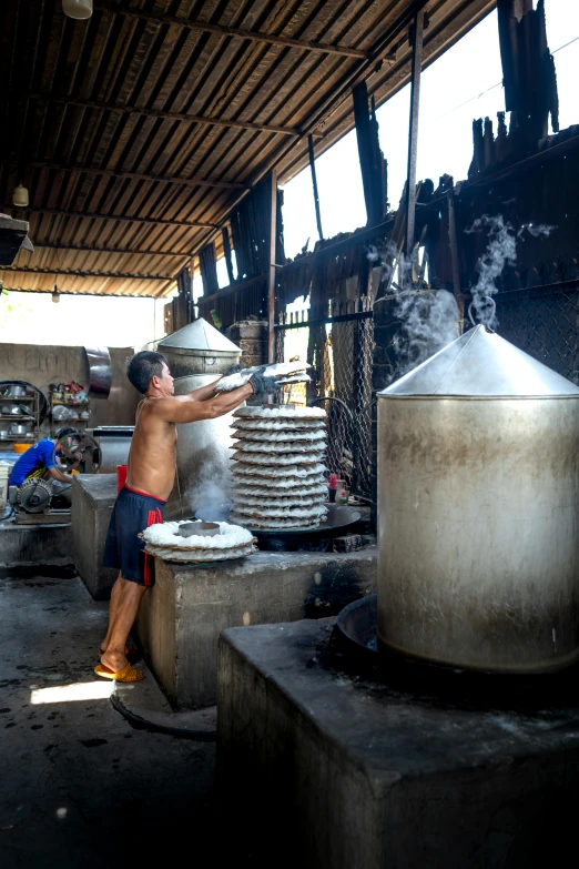 a man preparing food in a large pot