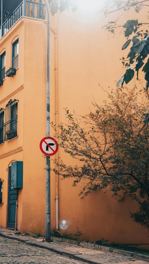 a red and white street sign on the side of a building