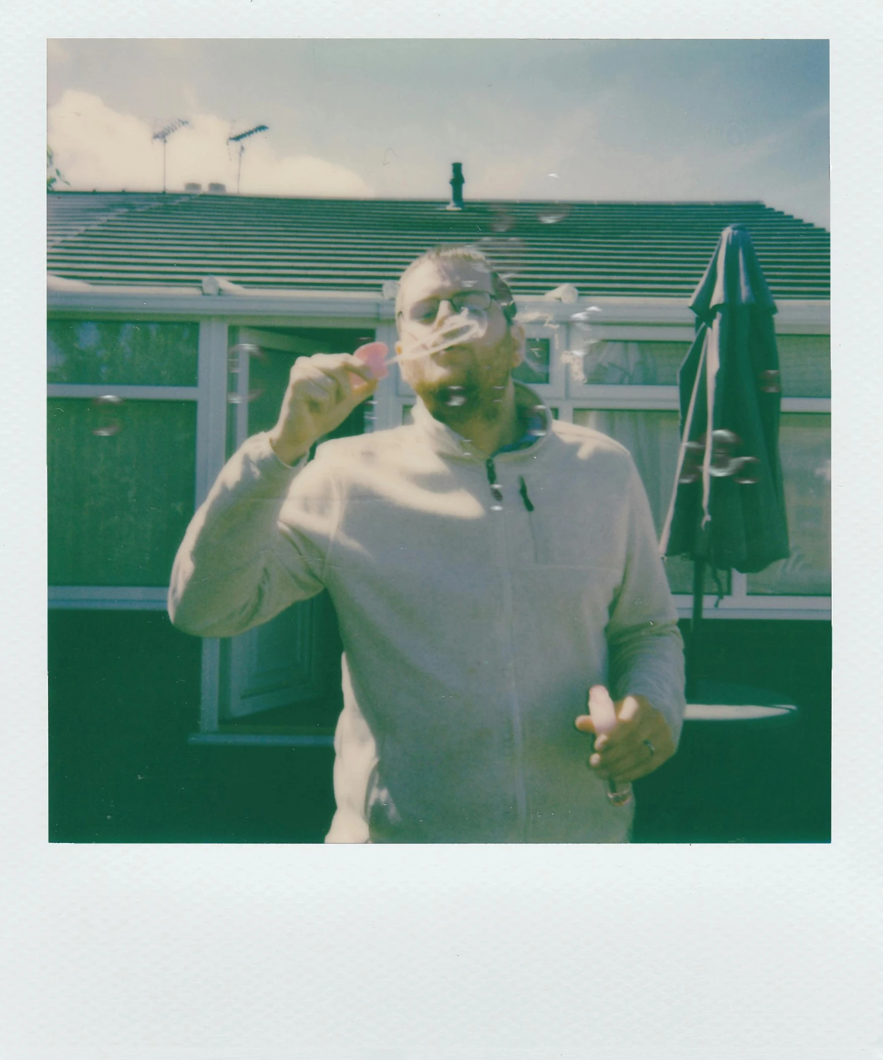 a person that is brushing his teeth in front of a house