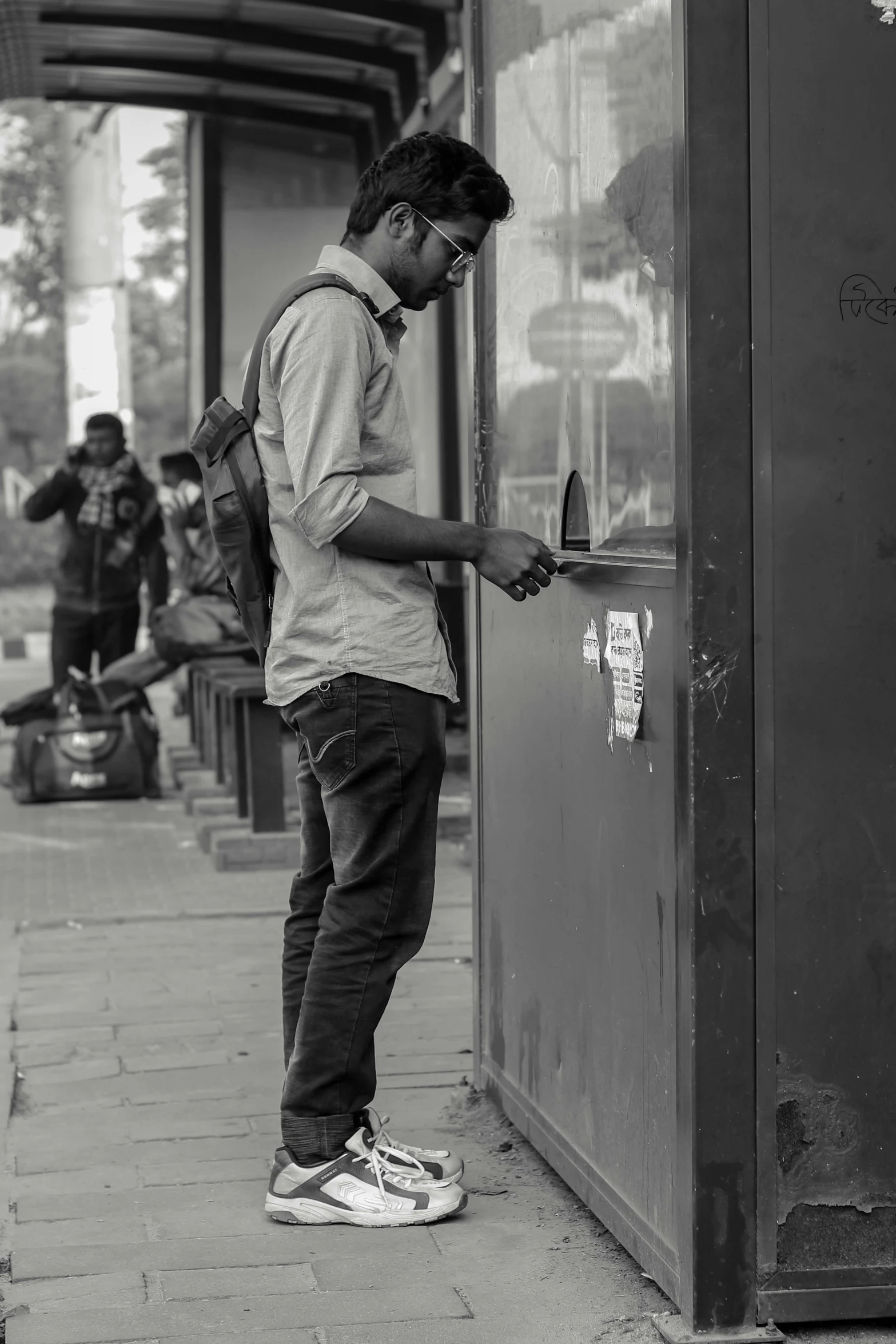 a man standing at a door looking down