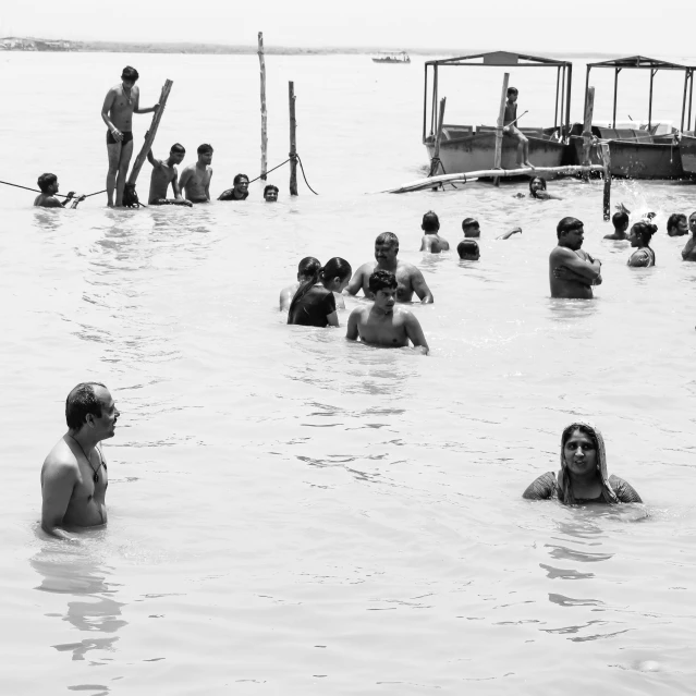 people swimming in the water near a boat