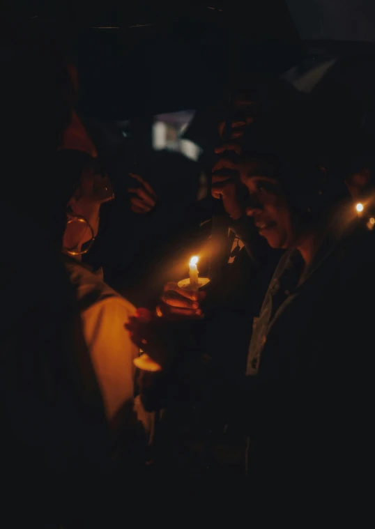 a bunch of people with candles in their hands