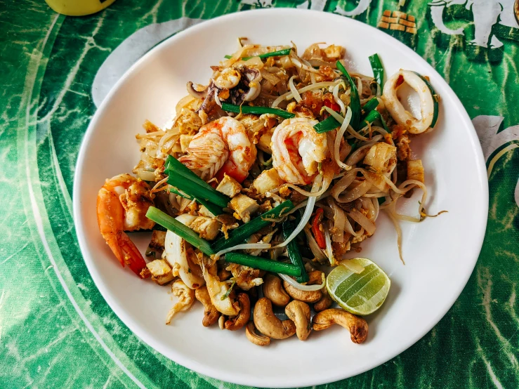 a bowl full of stir fried food on a table