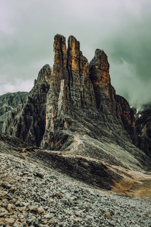 some tall mountains in the distance under a cloudy sky