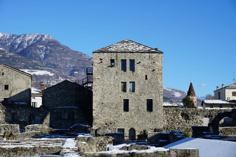 a castle like building with mountains in the back