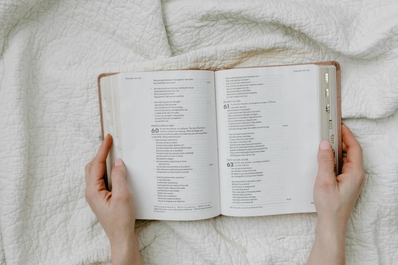 a person holds a book with words written on it