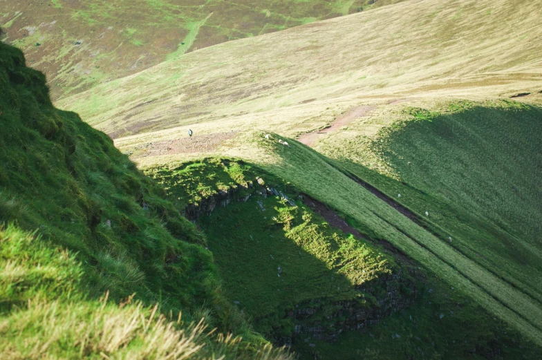 a grassy hillside with grass on both sides