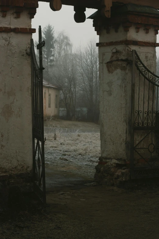 an open gate is seen between two buildings