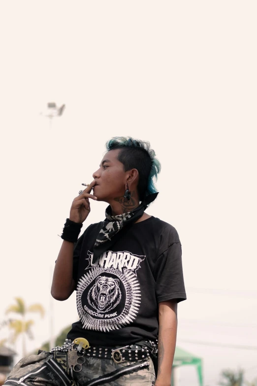 a lady with green hair smoking a cigarette