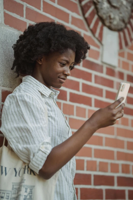 a woman holding a cellphone and looking at her other side