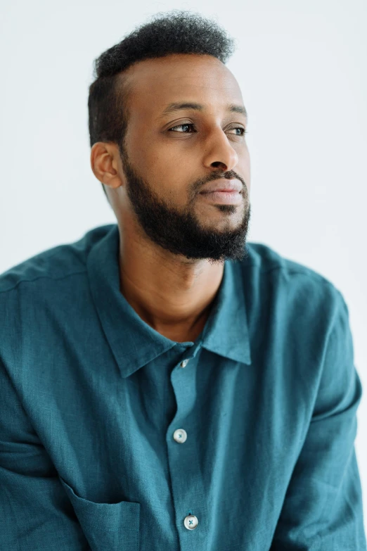 a man in a blue shirt looking into the distance