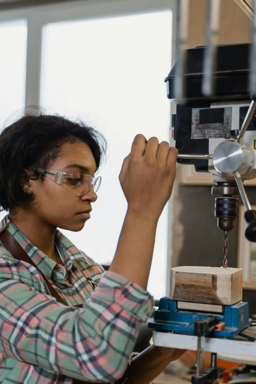 a woman working on a project in a workshop