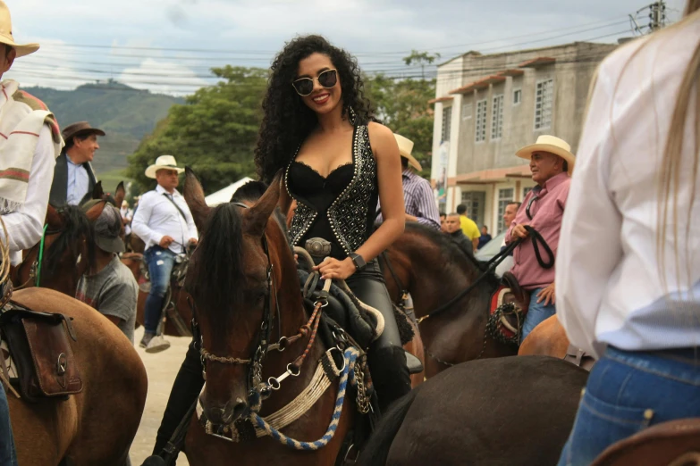 the woman is riding on her horses in the street