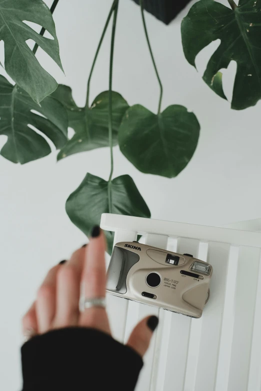 a person is pointing to an old camera