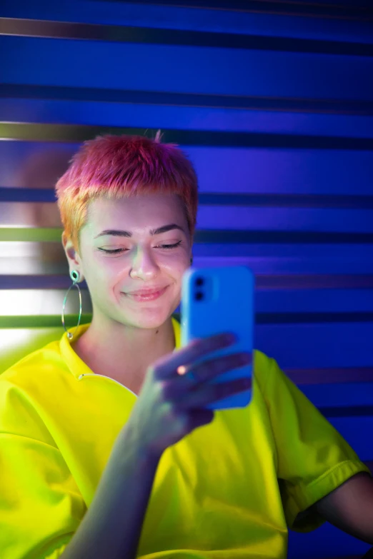 a young woman looking at her phone and smiling