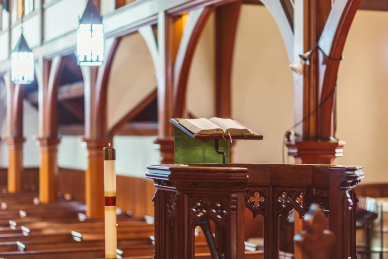 a wooden pulpit with an open book on top