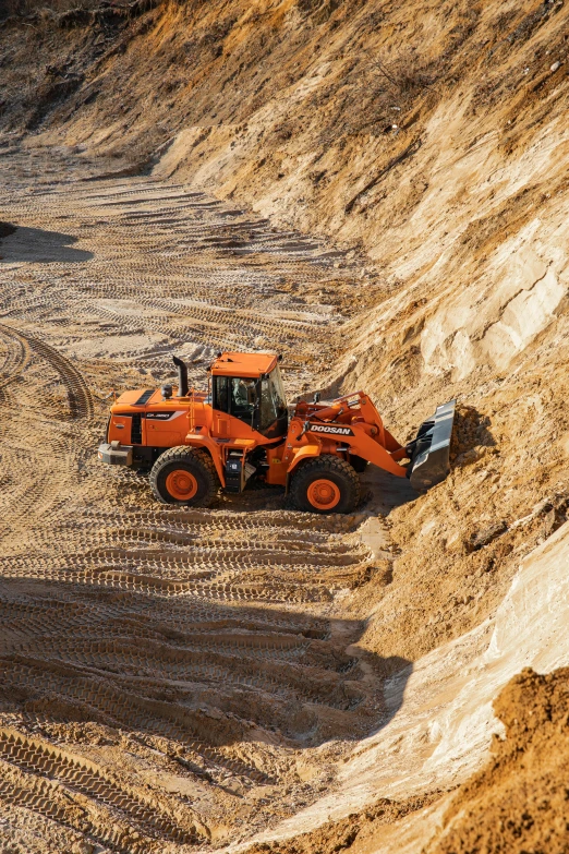 two large tractors are moving through a quarry