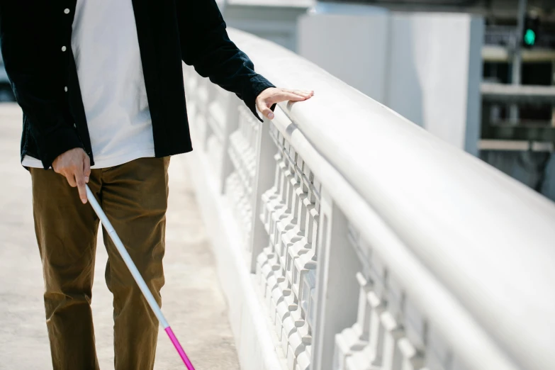 a person holding onto the railing of an outside area