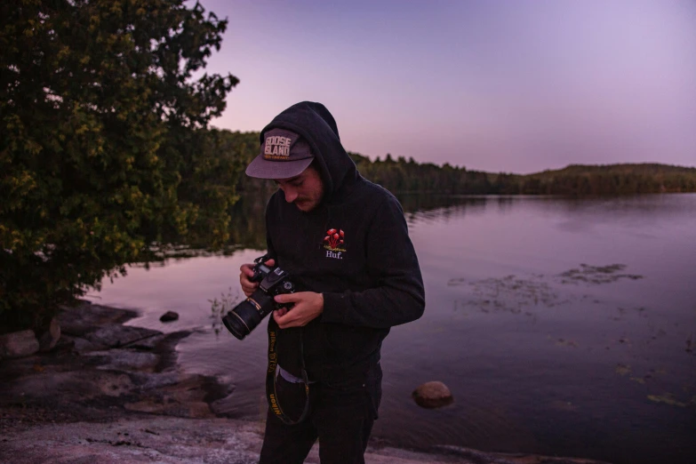 a man standing on a rock with his camera