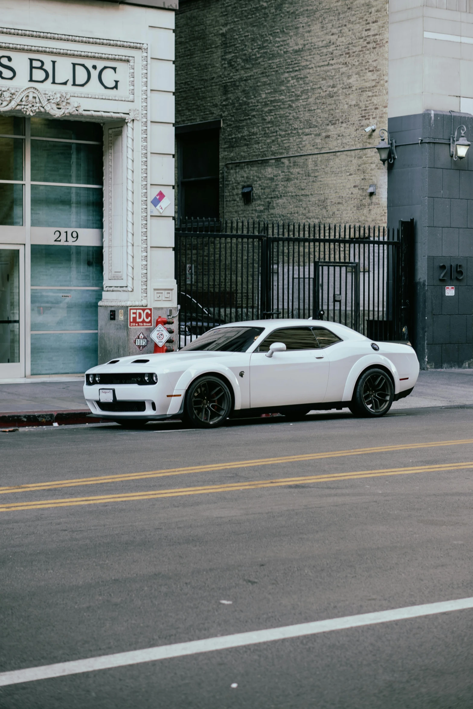 a white sports car parked in front of a store