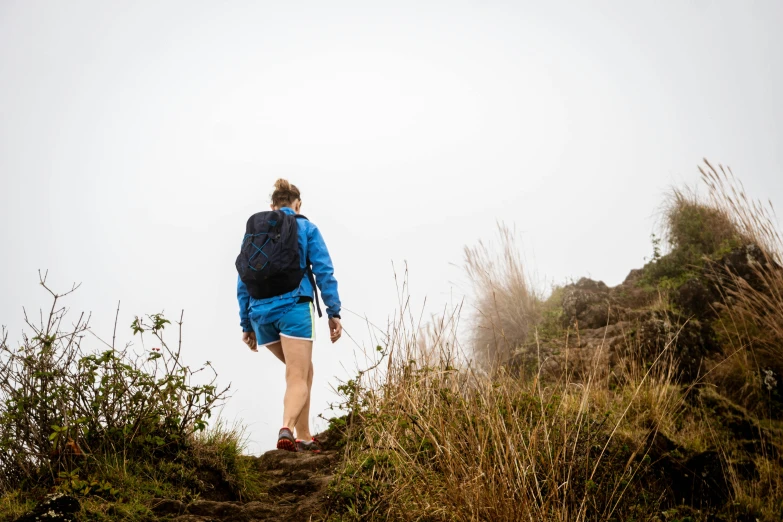 a person with a backpack is on a rocky hill