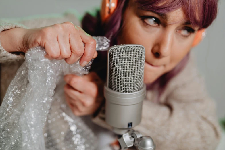 a woman in white jacket holding a microphone