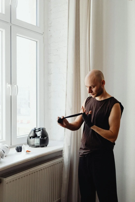 a man standing in front of a window with a pen