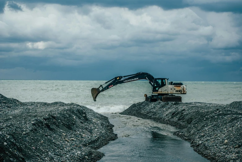 a tractor in the ocean going up a hill