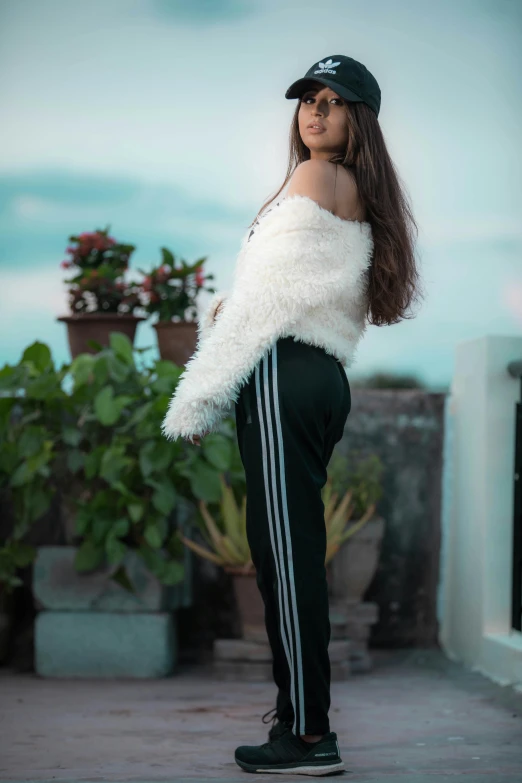 woman in white and black outfit wearing a hat